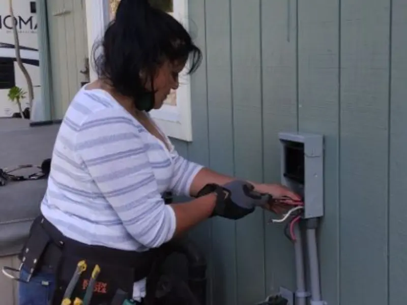 Licensed electrician wiring an exterior subpanel in Fremont